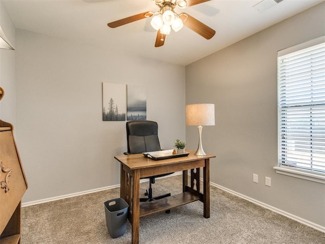 office area featuring visible vents, carpet flooring, baseboards, and ceiling fan