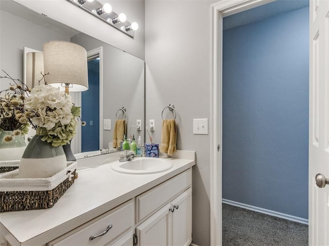 bathroom with vanity and baseboards