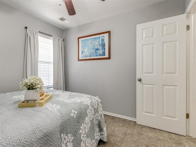 bedroom with visible vents, carpet flooring, baseboards, and a ceiling fan