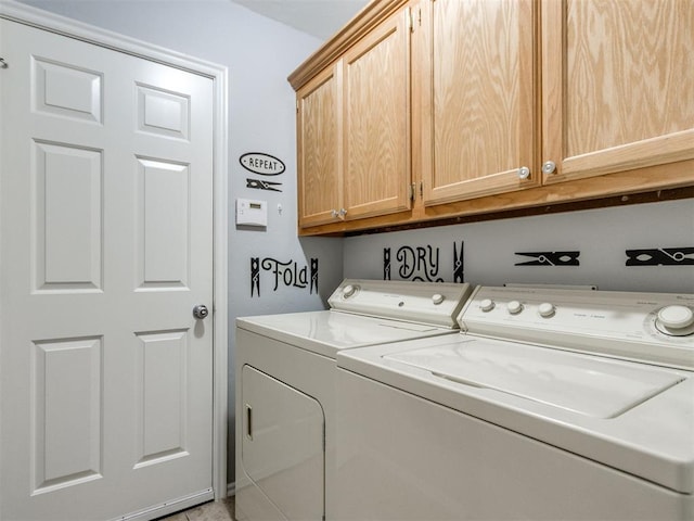 clothes washing area with cabinet space and washing machine and dryer