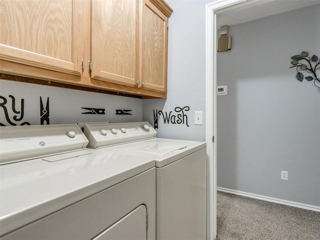 washroom featuring carpet floors, baseboards, washing machine and dryer, and cabinet space
