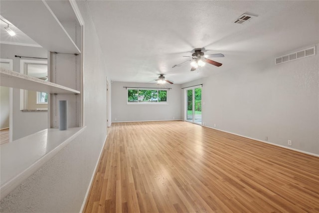 2417 NW 55th Ter, Oklahoma City, OK 73112 - unfurnished living room featuring baseboards, ceiling fan, light wood finished floors, and visible vents