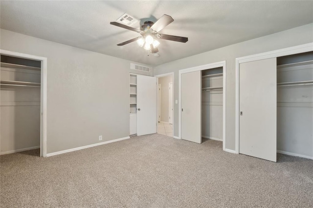 2417 NW 55th Ter, Oklahoma City, OK 73112 - unfurnished bedroom with carpet floors, baseboards, visible vents, and two closets