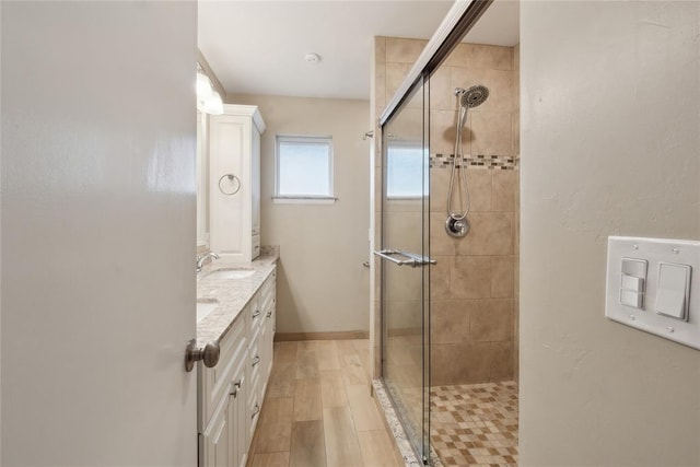 2417 NW 55th Ter, Oklahoma City, OK 73112 - bathroom with double vanity, a sink, and a stall shower