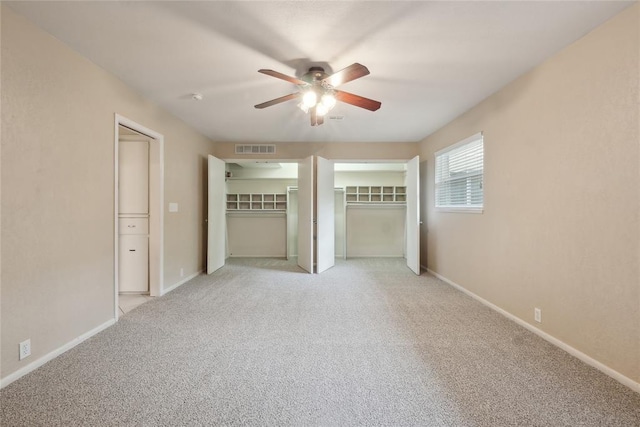 2417 NW 55th Ter, Oklahoma City, OK 73112 - unfurnished bedroom featuring light colored carpet, baseboards, visible vents, and ceiling fan