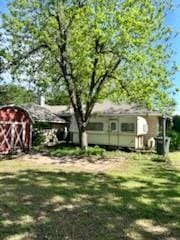 view of yard with a storage unit and an outbuilding