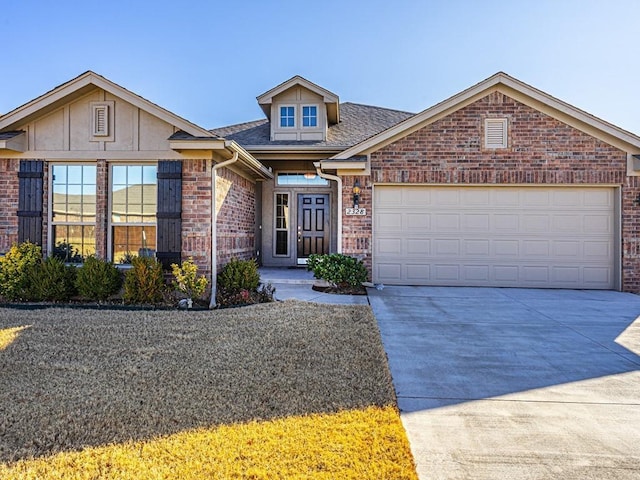 view of front of house with brick siding, a garage, a shingled roof, and concrete driveway