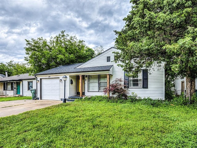 view of front facade with a shingled roof, an attached garage, a front lawn, covered porch, and driveway
