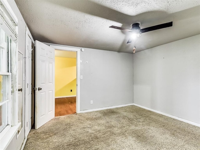 unfurnished bedroom featuring baseboards, ceiling fan, and carpet flooring