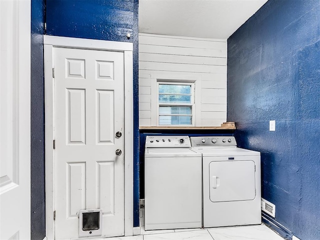 laundry area with laundry area, washer and dryer, and visible vents