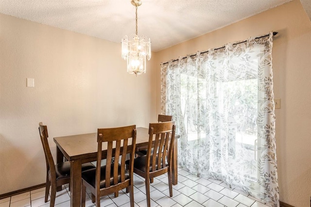 dining room with baseboards, a textured ceiling, a chandelier, and light tile patterned floors