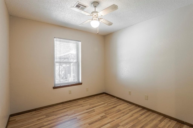 unfurnished room featuring visible vents, baseboards, a textured ceiling, a ceiling fan, and light wood finished floors