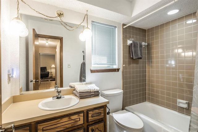 full bath featuring vanity, a textured ceiling, shower / bathtub combination, and toilet