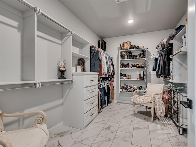 spacious closet featuring marble finish floor