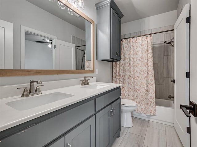 full bath with double vanity, toilet, shower / bath combination with curtain, and a sink