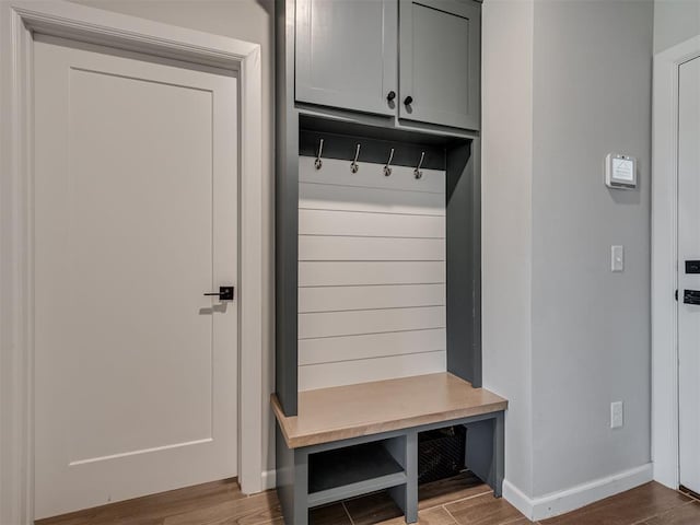 mudroom with baseboards and wood finished floors