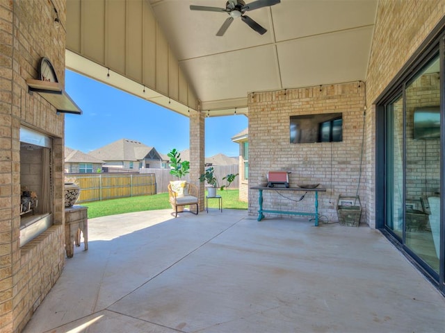 view of patio with a fenced backyard, ceiling fan, and a residential view