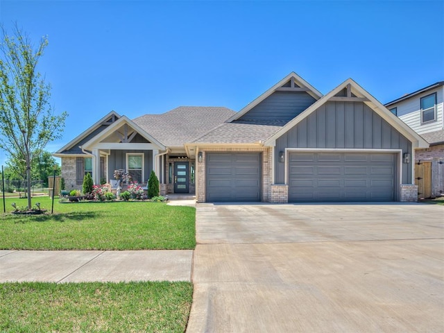 craftsman-style house with board and batten siding, driveway, a front yard, and a garage