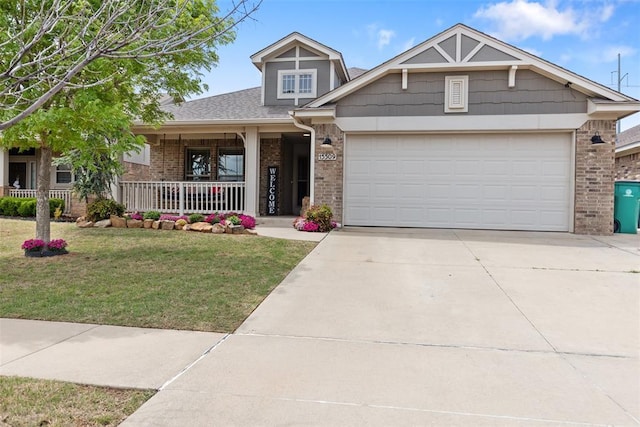 craftsman-style house featuring a porch, brick siding, a front lawn, concrete driveway, and an attached garage