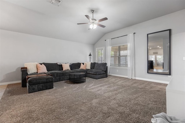 carpeted living area featuring visible vents, baseboards, ceiling fan, and vaulted ceiling