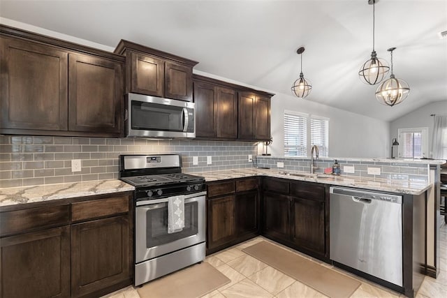 kitchen featuring a sink, a peninsula, a healthy amount of sunlight, and stainless steel appliances