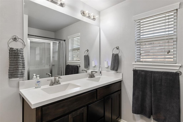bathroom with a sink, a shower with curtain, and double vanity