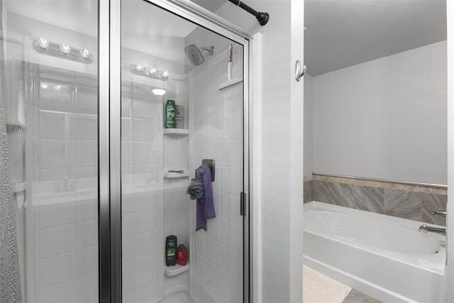 full bath with a garden tub and a stall shower