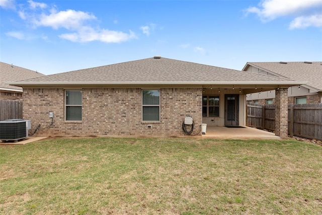 back of property featuring a fenced backyard, a patio area, and roof with shingles