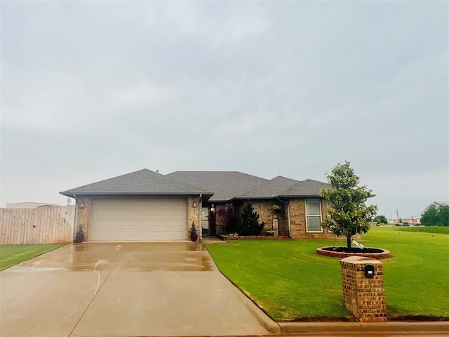 107 Chuckwagon Way, Elk City, OK 73644 - view of front of house featuring concrete driveway, brick siding, a front lawn, and a garage
