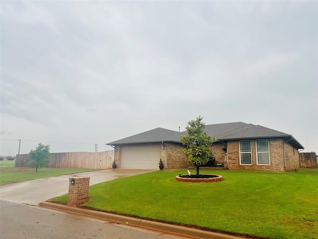 107 Chuckwagon Way, Elk City, OK 73644 - ranch-style house featuring fence, brick siding, a garage, a front yard, and concrete driveway