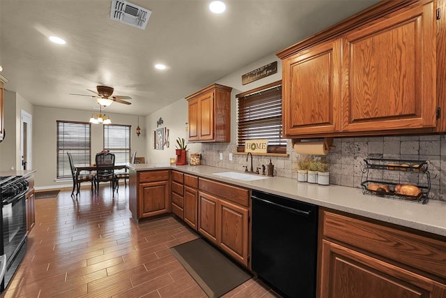 107 Chuckwagon Way, Elk City, OK 73644 - kitchen with visible vents, tasteful backsplash, a sink, light countertops, and black appliances