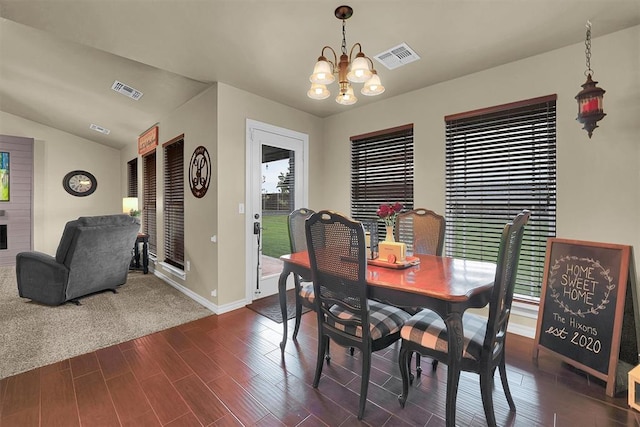 107 Chuckwagon Way, Elk City, OK 73644 - dining area with baseboards, an inviting chandelier, dark wood finished floors, and visible vents