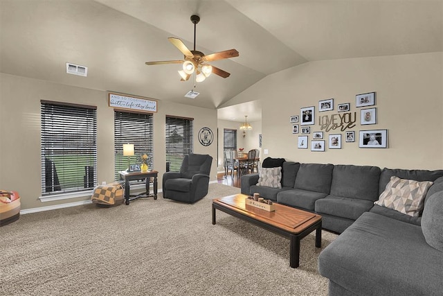 107 Chuckwagon Way, Elk City, OK 73644 - living room with carpet flooring, vaulted ceiling, visible vents, and ceiling fan with notable chandelier