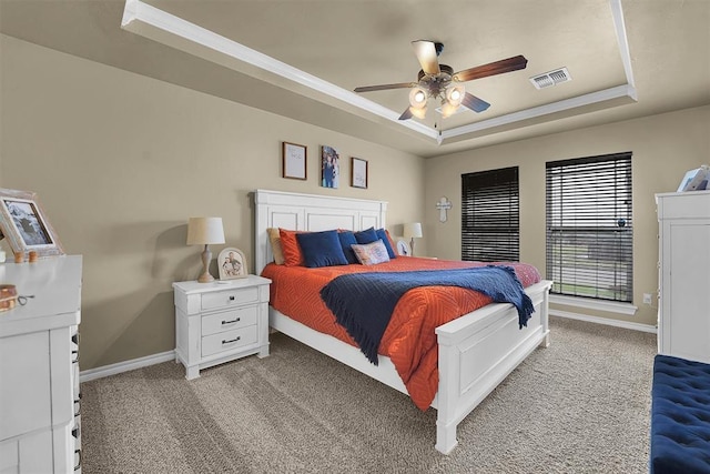 107 Chuckwagon Way, Elk City, OK 73644 - bedroom with visible vents, baseboards, a tray ceiling, and light colored carpet