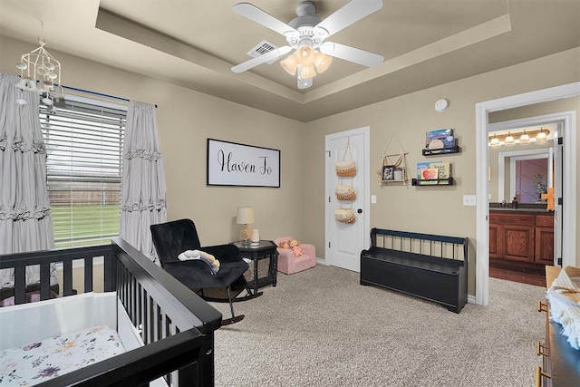 107 Chuckwagon Way, Elk City, OK 73644 - bedroom with visible vents, carpet flooring, baseboards, and a tray ceiling