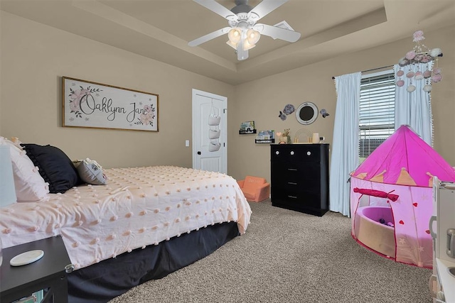 107 Chuckwagon Way, Elk City, OK 73644 - bedroom with carpet floors, ceiling fan, and a tray ceiling
