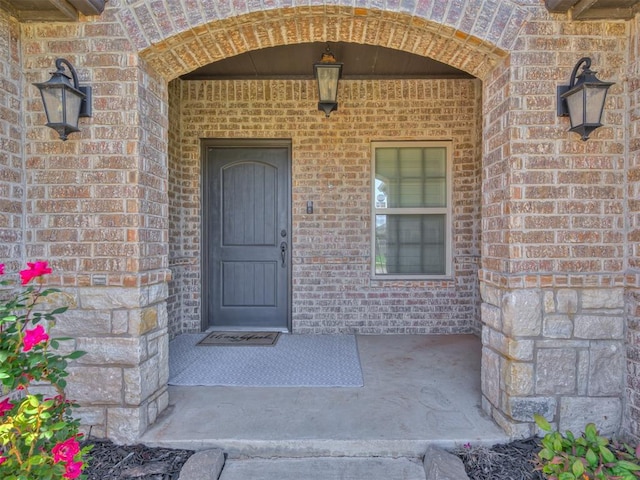 view of exterior entry with brick siding