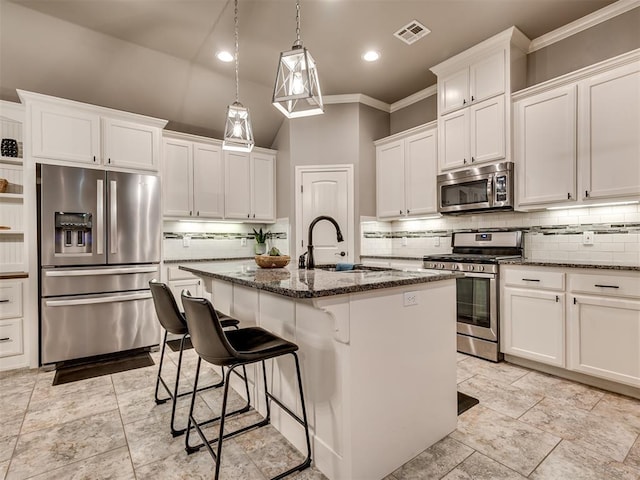 kitchen featuring visible vents, decorative backsplash, crown molding, a sink, and appliances with stainless steel finishes