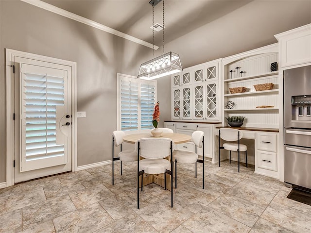 dining area featuring crown molding, baseboards, a high ceiling, and visible vents