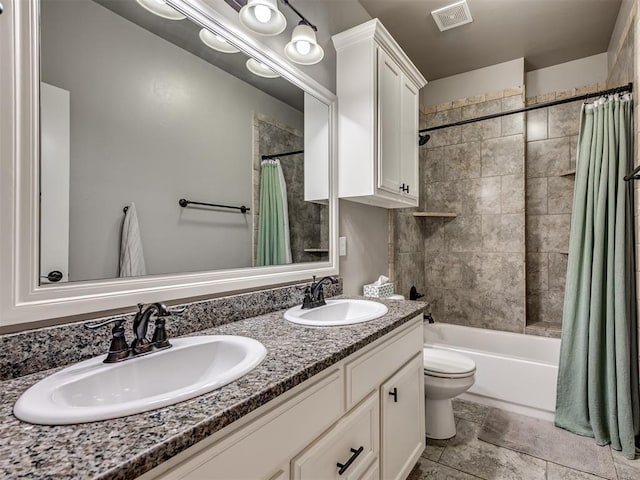 bathroom featuring a sink, shower / bath combination with curtain, double vanity, and visible vents