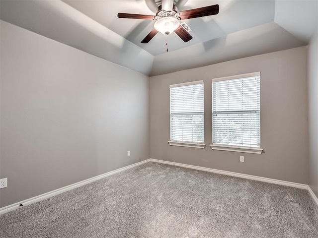 unfurnished room featuring baseboards, a raised ceiling, carpet, and ceiling fan