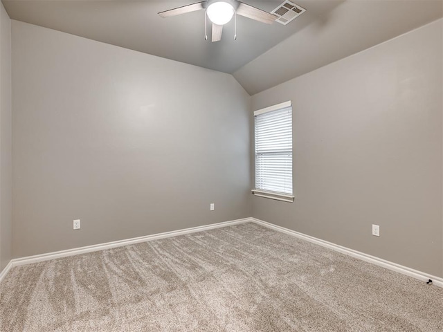 carpeted spare room with a ceiling fan, baseboards, visible vents, and lofted ceiling