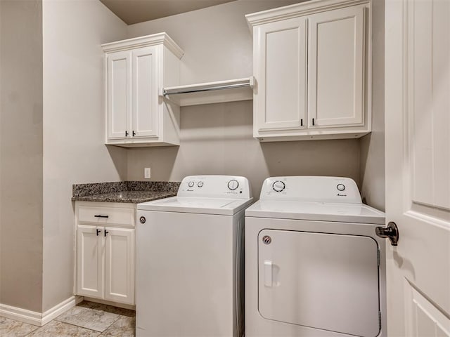 laundry room with baseboards, washer and clothes dryer, and cabinet space