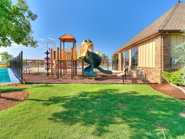 community playground featuring fence and a yard