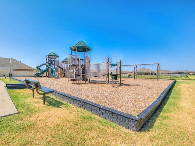 communal playground featuring a lawn