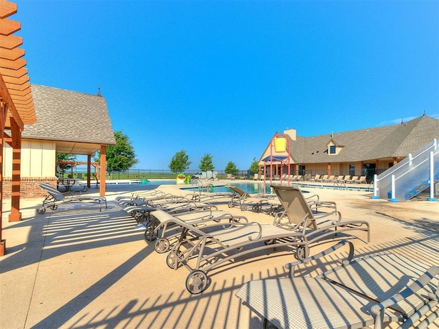 pool featuring fence and a patio area