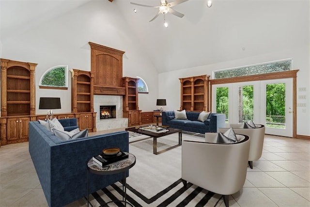 12700 Jabez Rd, Edmond, OK 73013 - living room featuring high vaulted ceiling, a high end fireplace, healthy amount of natural light, a ceiling fan, and light tile patterned flooring