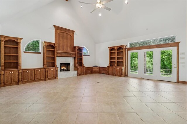 12700 Jabez Rd, Edmond, OK 73013 - unfurnished living room with high vaulted ceiling, ceiling fan, a fireplace, and light tile patterned flooring