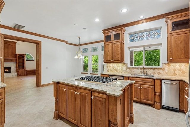12700 Jabez Rd, Edmond, OK 73013 - kitchen with stainless steel appliances, brown cabinets, backsplash, light stone counters, and light tile patterned flooring