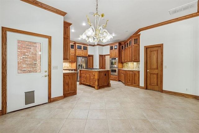 12700 Jabez Rd, Edmond, OK 73013 - kitchen with brown cabinetry, appliances with stainless steel finishes, a chandelier, tasteful backsplash, and light countertops